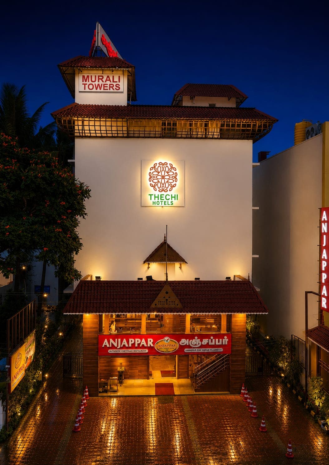 Thechi Hotel, Hosur — illuminated exterior at dusk on NH-44
